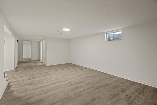 interior space featuring wood finished floors and baseboards