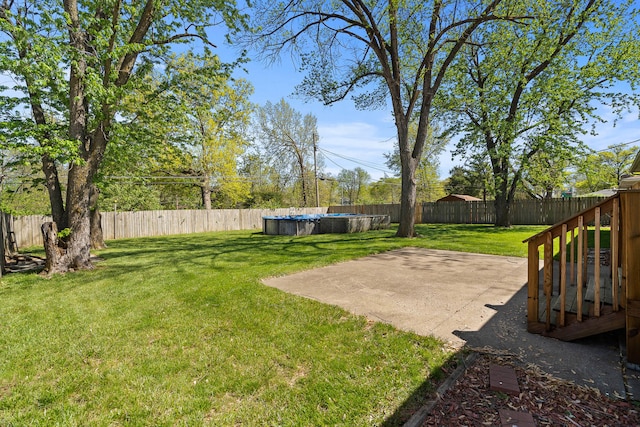 view of yard with a fenced backyard, a fenced in pool, and a patio