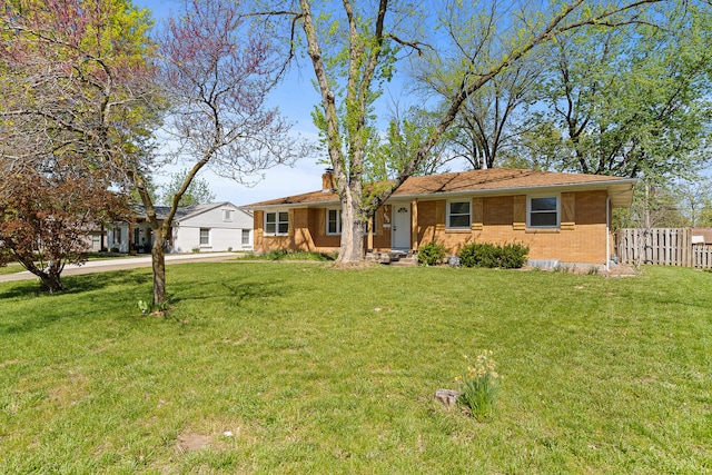 ranch-style house with brick siding, a front lawn, a chimney, and fence