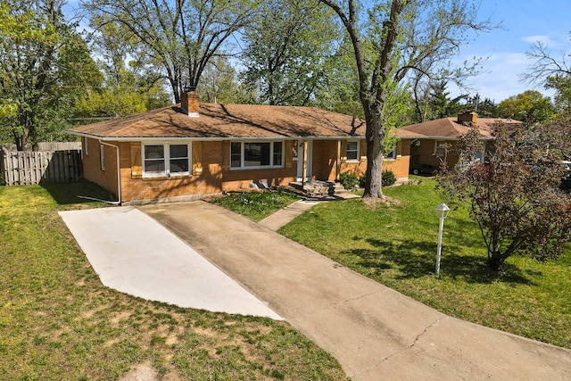 single story home with brick siding, fence, a chimney, and a front lawn