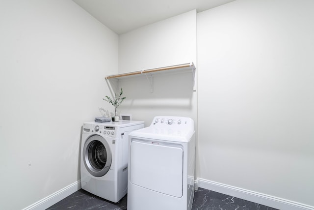 washroom with laundry area, baseboards, marble finish floor, and independent washer and dryer