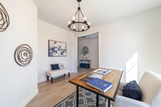 office area with baseboards, a chandelier, and light wood-style floors