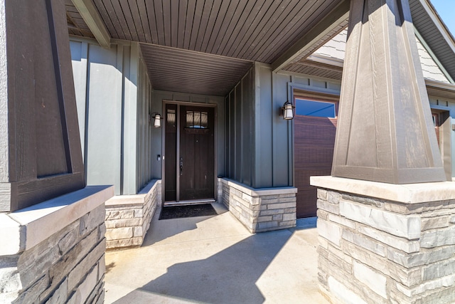 property entrance with stone siding