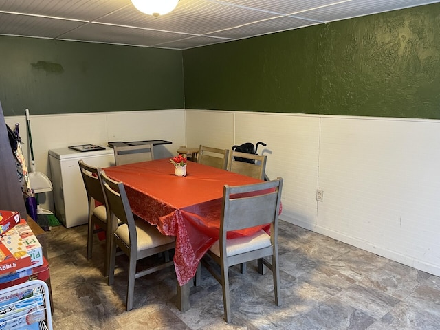 dining area featuring a textured wall