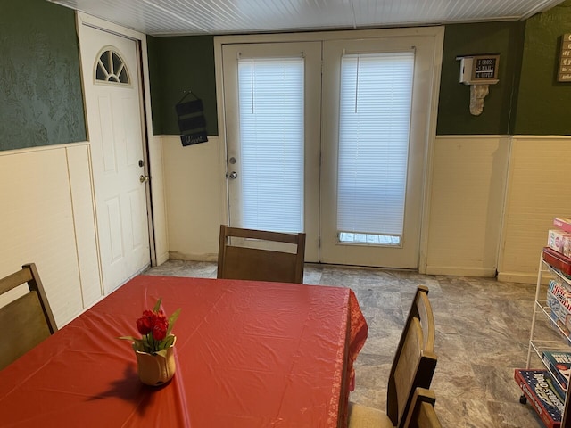 dining area with a wainscoted wall