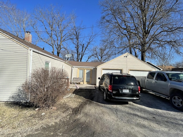 exterior space with driveway and an attached garage