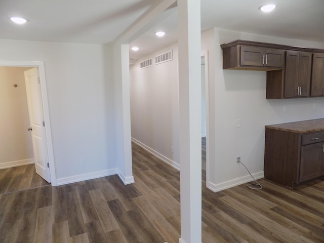 interior space featuring recessed lighting, dark wood finished floors, visible vents, and baseboards