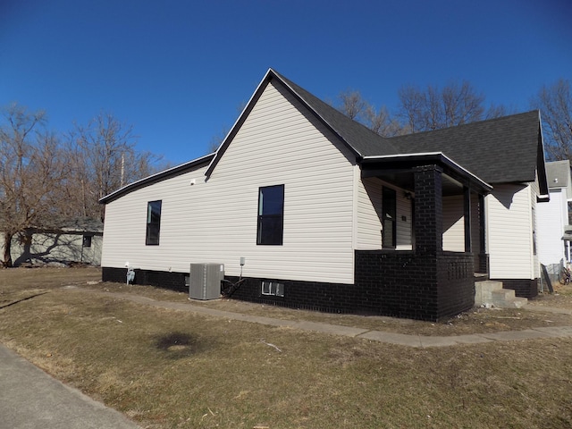 view of property exterior with central air condition unit and covered porch