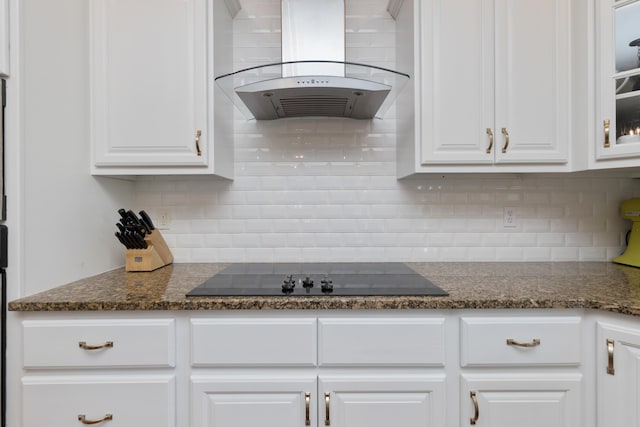 kitchen with white cabinetry, island exhaust hood, black electric stovetop, and tasteful backsplash