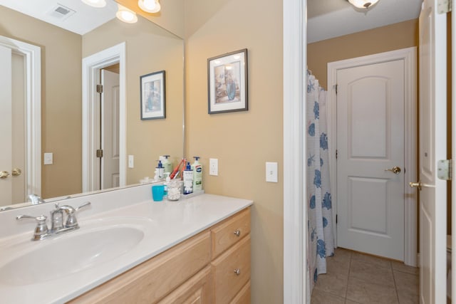 full bathroom featuring visible vents, vanity, and tile patterned floors