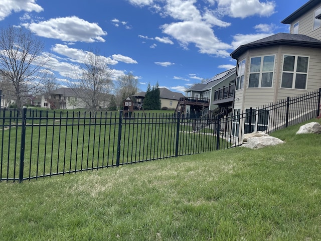 view of yard featuring a fenced backyard, a residential view, and a wooden deck