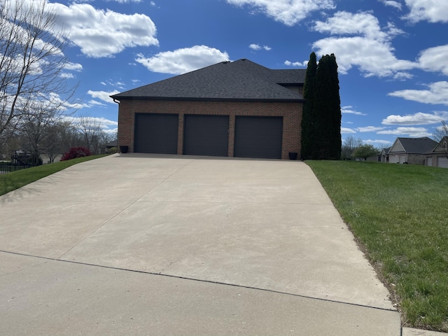 view of property exterior featuring a garage, brick siding, a shingled roof, a yard, and concrete driveway