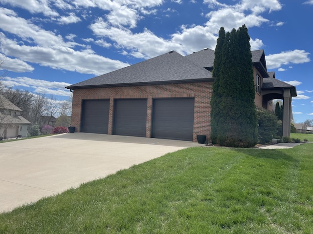 view of home's exterior featuring brick siding, roof with shingles, concrete driveway, a lawn, and an attached garage