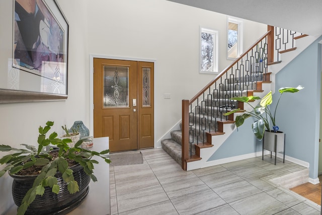 entryway with stairs and baseboards