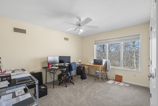 office area featuring a textured ceiling, carpet, visible vents, and baseboards