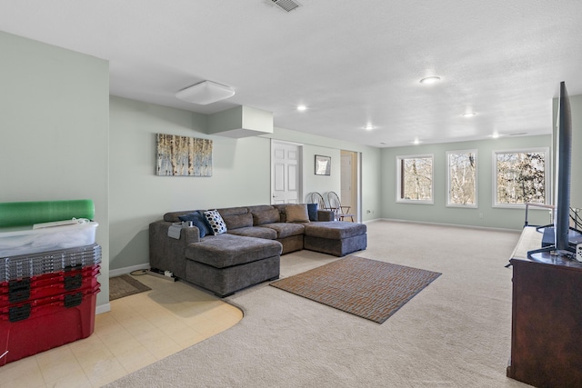 carpeted living room featuring visible vents, baseboards, and recessed lighting