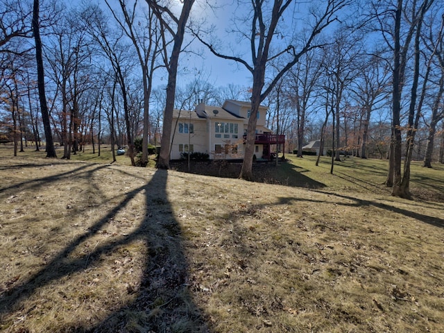 view of side of property featuring a deck and a yard