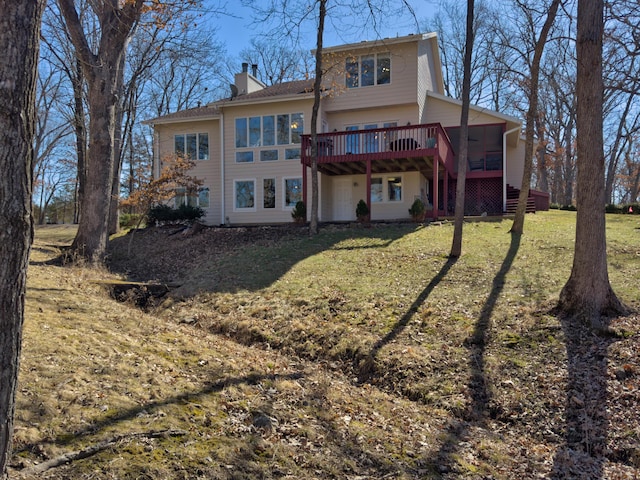 rear view of property with a chimney, stairway, a lawn, and a wooden deck