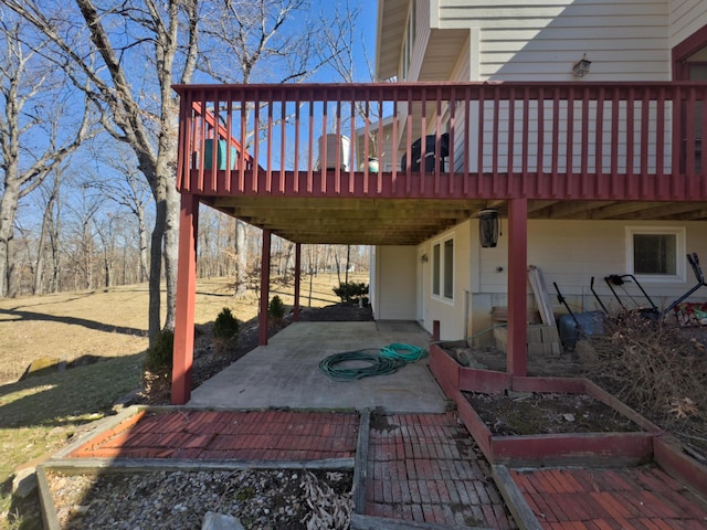 view of patio with a wooden deck and a vegetable garden