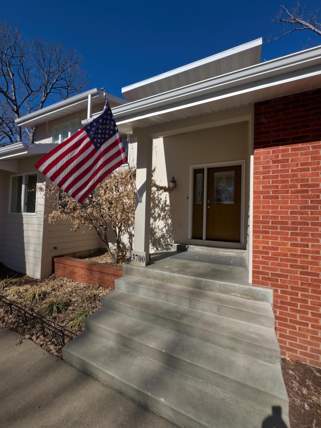 property entrance featuring brick siding