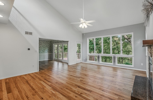 3700 S Joan Ct, Columbia, MO 65201 - unfurnished living room with a stone fireplace, a ceiling fan, light wood-style flooring, high vaulted ceiling, and recessed lighting
