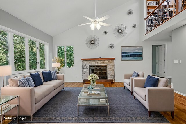 3700 S Joan Ct, Columbia, MO 65201 - living area featuring high vaulted ceiling, a ceiling fan, wood finished floors, and a glass covered fireplace