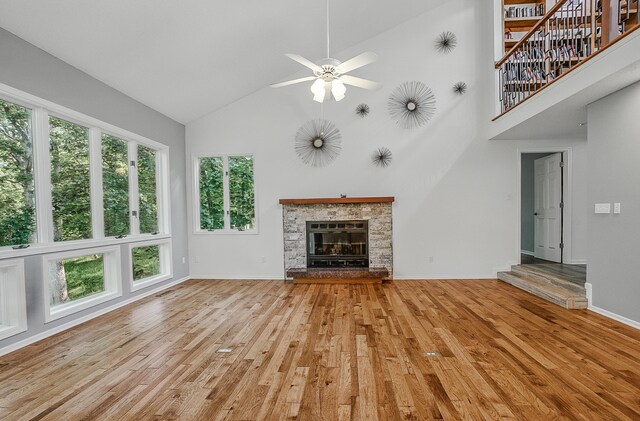 3700 S Joan Ct, Columbia, MO 65201 - unfurnished living room with high vaulted ceiling, light wood-style flooring, ceiling fan, and a glass covered fireplace