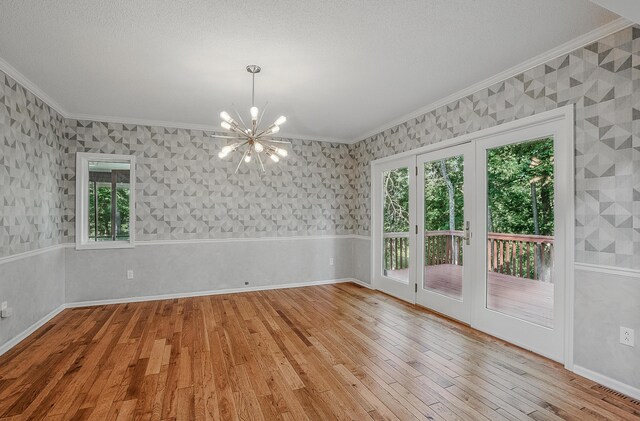 3700 S Joan Ct, Columbia, MO 65201 - empty room featuring crown molding, a chandelier, hardwood / wood-style floors, wallpapered walls, and healthy amount of natural light