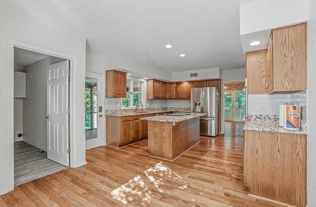 3700 S Joan Ct, Columbia, MO 65201 - kitchen with stainless steel fridge, a kitchen island, light wood finished floors, tasteful backsplash, and recessed lighting