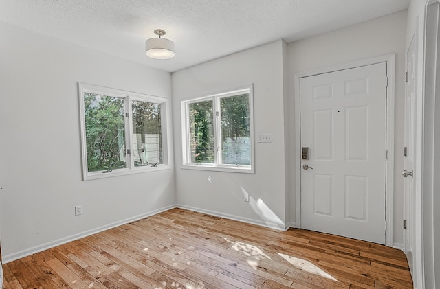 3700 S Joan Ct, Columbia, MO 65201 - entryway with light wood-style flooring and a textured ceiling