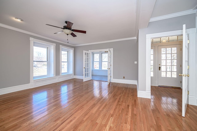 entrance foyer featuring light wood-type flooring, french doors, and crown molding