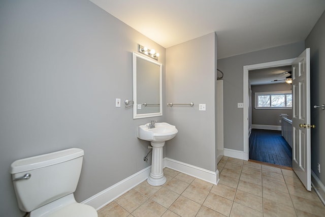 full bath with a shower, tile patterned flooring, baseboards, and toilet