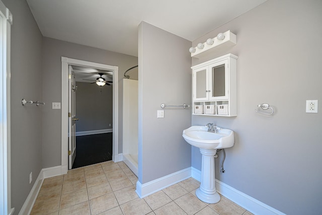 bathroom featuring a shower stall, baseboards, and tile patterned floors