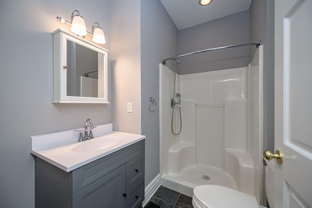 bathroom featuring toilet, tile patterned floors, a shower, and vanity