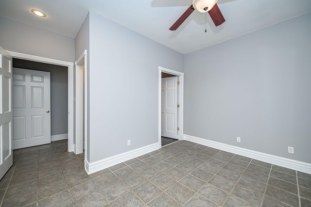 unfurnished bedroom with ceiling fan and baseboards