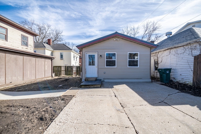 rear view of property featuring fence