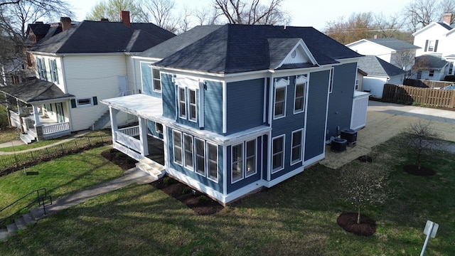 414 N Church, Fayette, MO 65248 - back of house with a lawn, a sunroom, fence, and roof with shingles