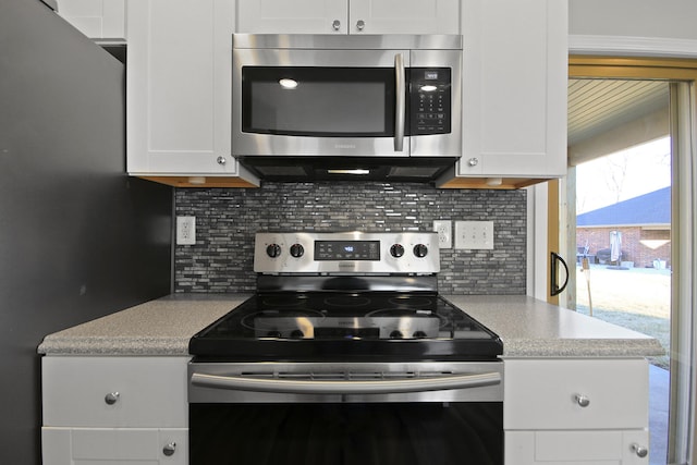 kitchen with light countertops, appliances with stainless steel finishes, and white cabinetry