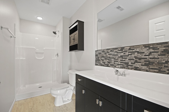 full bath with visible vents, decorative backsplash, toilet, walk in shower, and vanity