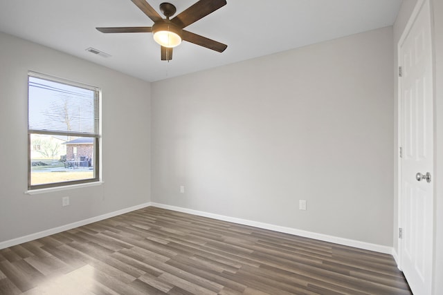 unfurnished bedroom featuring a ceiling fan, wood finished floors, visible vents, and baseboards