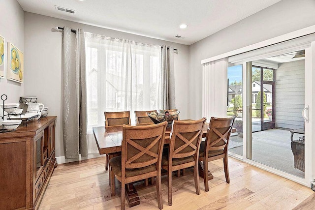 dining area featuring visible vents and light wood finished floors