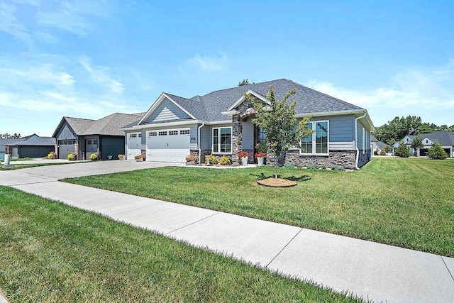 craftsman-style house with a garage, a shingled roof, stone siding, concrete driveway, and a front yard