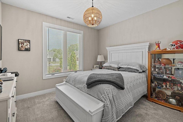 bedroom featuring a chandelier, light colored carpet, visible vents, and baseboards