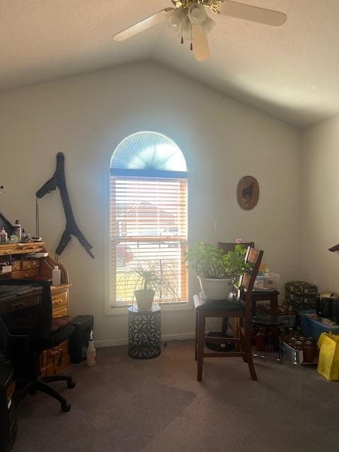 home office featuring carpet floors, vaulted ceiling, and ceiling fan