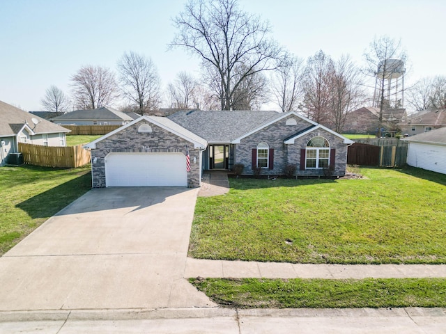 single story home with concrete driveway, an attached garage, fence, and a front yard