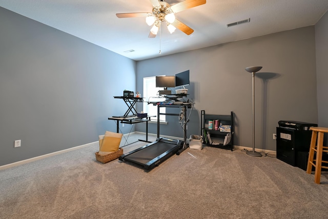 exercise area featuring carpet, visible vents, ceiling fan, and baseboards