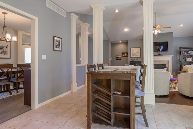 kitchen with visible vents, ornate columns, and light tile patterned floors