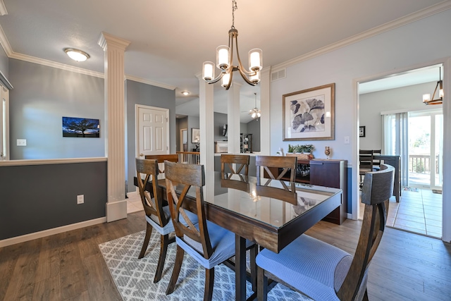 dining room featuring crown molding, visible vents, baseboards, dark wood-type flooring, and ornate columns