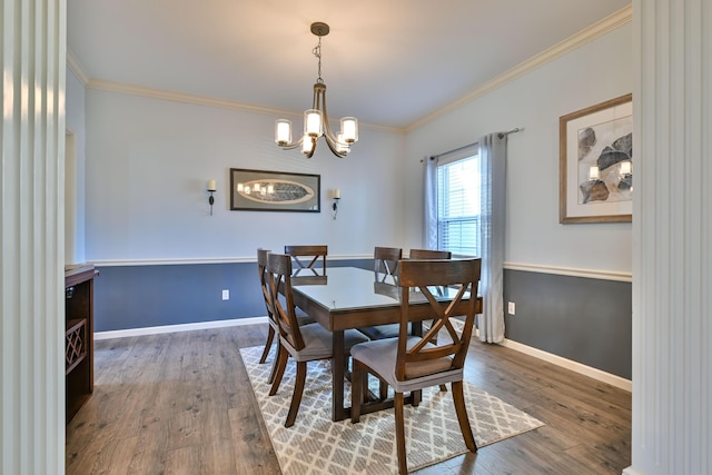 dining area with ornamental molding, wood finished floors, and baseboards