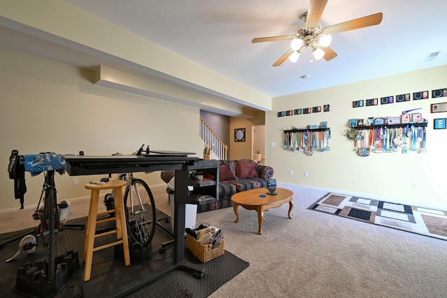 exercise room featuring a ceiling fan, carpet flooring, visible vents, and baseboards